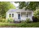Charming bungalow with a covered front porch, mature trees, and a well-maintained lawn at 2523 Glendale Ave, Durham, NC 27704