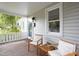 Cozy front porch with wooden chairs, decorative pillows, and a view of the surrounding greenery at 2523 Glendale Ave, Durham, NC 27704