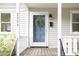 Inviting front porch with a blue door, wreath, and black address numbers at 2523 Glendale Ave, Durham, NC 27704