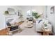 Bright living room with fireplace, stylish furniture, large windows, and beautiful hardwood floors at 2523 Glendale Ave, Durham, NC 27704