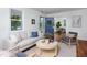Inviting living room with comfortable sofa and blue door leading to dining room at 2523 Glendale Ave, Durham, NC 27704
