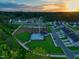Beautiful aerial view of a new neighborhood with pool and community amenities at sunset at 267 Meadowbark Bnd # 34, Garner, NC 27529