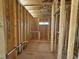Exposed framing of bathroom area in-progress, showcasing plumbing lines and window placement during construction at 267 Meadowbark Bnd # 34, Garner, NC 27529