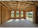 Framed living room showcasing the window placements, sliding glass door to the backyard, and exposed ceiling at 267 Meadowbark Bnd # 34, Garner, NC 27529