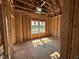 This framed bedroom is ready for insulation and drywall with natural light at 268 Meadowbark Bnd # 42, Garner, NC 27529