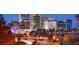 Striking city skyline view at dusk, featuring modern buildings and vibrant street lights at 268 Meadowbark Bnd # 42, Garner, NC 27529