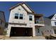 Two story home features covered porch and windows ready for exterior finishes at 268 Meadowbark Bnd # 42, Garner, NC 27529