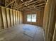 The framed primary bedroom is prepped for finishing with natural light at 268 Meadowbark Bnd # 42, Garner, NC 27529