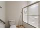 Bathroom with a white toilet and a bathtub with sliding glass doors at 300 Finsbury St # 109, Durham, NC 27703