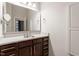 Bathroom featuring a large mirror, brown vanity with a quartz countertop at 300 Finsbury St # 109, Durham, NC 27703