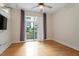 Bedroom with hardwood floors and glass doors to balcony at 300 Finsbury St # 109, Durham, NC 27703