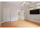 Bedroom with hardwood floors, a walk-in closet, and a wall-mounted TV at 300 Finsbury St # 109, Durham, NC 27703