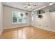 Bedroom with hardwood floors, a ceiling fan, and large window with view to outside at 300 Finsbury St # 109, Durham, NC 27703