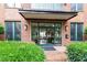 Building entrance with glass doors and manicured landscaping at 300 Finsbury St # 109, Durham, NC 27703