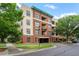 Apartment building exterior with brick and tan facade and green awnings at 300 Finsbury St # 109, Durham, NC 27703
