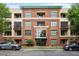 Brick building with green trim, professionally landscaped exterior, and covered entryway at 300 Finsbury St # 109, Durham, NC 27703