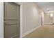 Hallway featuring carpet flooring, neutral paint, unit doors, and an emergency exit sign at 300 Finsbury St # 109, Durham, NC 27703