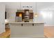 Open kitchen with stainless steel appliances, granite countertops, and a breakfast bar at 300 Finsbury St # 109, Durham, NC 27703