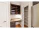 Kitchen area features a built-in desk, cabinets, and a pantry with shelving for storage at 300 Finsbury St # 109, Durham, NC 27703