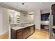Spacious kitchen featuring granite countertops, stainless steel appliances, and adjacent built in desk at 300 Finsbury St # 109, Durham, NC 27703