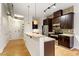 Modern kitchen featuring granite countertops, stainless steel appliances, and dark wood cabinetry at 300 Finsbury St # 109, Durham, NC 27703