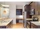 Modern kitchen with granite countertops, stainless steel appliances, and a built in desk/shelving area at 300 Finsbury St # 109, Durham, NC 27703