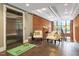 Stylish lobby with an elevator, seating area, brick accent wall, and modern lighting at 300 Finsbury St # 109, Durham, NC 27703