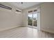 A bright bedroom featuring vinyl floors, a sliding glass door, and neutral paint at 300 Finsbury St # 309, Durham, NC 27703