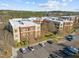 Condominium building with brick and siding, parking, landscaping, and a view of the surrounding neighborhood at 300 Finsbury St # 309, Durham, NC 27703