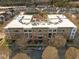 Brick condominium building with private balconies surrounded by mature trees and common grounds at 300 Finsbury St # 309, Durham, NC 27703