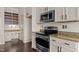 Stylish kitchen features modern stainless steel appliances and granite countertops at 300 Finsbury St # 309, Durham, NC 27703
