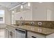 Close-up of kitchen island featuring granite countertops, stainless steel dishwasher, and fixtures at 300 Finsbury St # 309, Durham, NC 27703