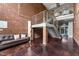 Spacious lobby with staircase, brick walls, and comfortable seating area provides a welcoming entrance to the building at 300 Finsbury St # 309, Durham, NC 27703