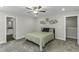 Cozy bedroom with neutral walls, carpet flooring, ceiling fan, and minimalist decor at 301 Sawgrass Ct, Mebane, NC 27302