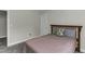 This bedroom features gray carpet, neutral walls, and a wood headboard at 301 Sawgrass Ct, Mebane, NC 27302