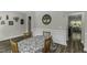 Cozy dining area with wood floors, decorative wainscoting, and a charming tree art piece at 301 Sawgrass Ct, Mebane, NC 27302