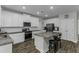 Open kitchen with white cabinets, granite counters, a central island, and stainless steel appliances at 301 Sawgrass Ct, Mebane, NC 27302