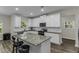 Modern kitchen with white cabinets, granite countertops, large island, and stainless steel appliances at 301 Sawgrass Ct, Mebane, NC 27302
