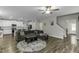Open-concept living room boasts hardwood floors and connects seamlessly with a kitchen and staircase at 301 Sawgrass Ct, Mebane, NC 27302