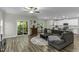 Spacious living room with a sectional sofa, hardwood floors, and seamless access to the outdoor deck at 301 Sawgrass Ct, Mebane, NC 27302