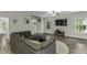 Spacious living room features hardwood floors, large sectional sofa, and staircase access at 301 Sawgrass Ct, Mebane, NC 27302