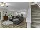 Open-concept living room with a comfortable sofa, modern flooring, and a view into the kitchen at 301 Sawgrass Ct, Mebane, NC 27302