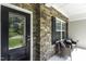 Inviting porch with stone accents and comfortable seating, perfect for relaxing outdoors at 301 Sawgrass Ct, Mebane, NC 27302