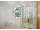 Bright bathroom features a soaking tub and a separate glass-enclosed shower at 3021 Glenwood Dr, Durham, NC 27705