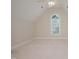 Bright bedroom featuring vaulted ceiling, neutral color palette, and arched window with natural light at 3021 Glenwood Dr, Durham, NC 27705