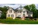 Elegant brick home featuring a well-maintained lawn and lush greenery at 3021 Glenwood Dr, Durham, NC 27705