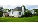 Side exterior view of a two-story home with a well-kept lawn and mature landscaping at 3021 Glenwood Dr, Durham, NC 27705