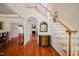 Inviting foyer with hardwood floors, staircase, and elegant decorative mirror at 3021 Glenwood Dr, Durham, NC 27705