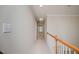 Neutral hallway featuring carpet flooring, white walls, and wood railing at 3021 Glenwood Dr, Durham, NC 27705