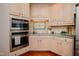 Modern kitchen with stainless steel appliances and custom tile work around the range at 3021 Glenwood Dr, Durham, NC 27705